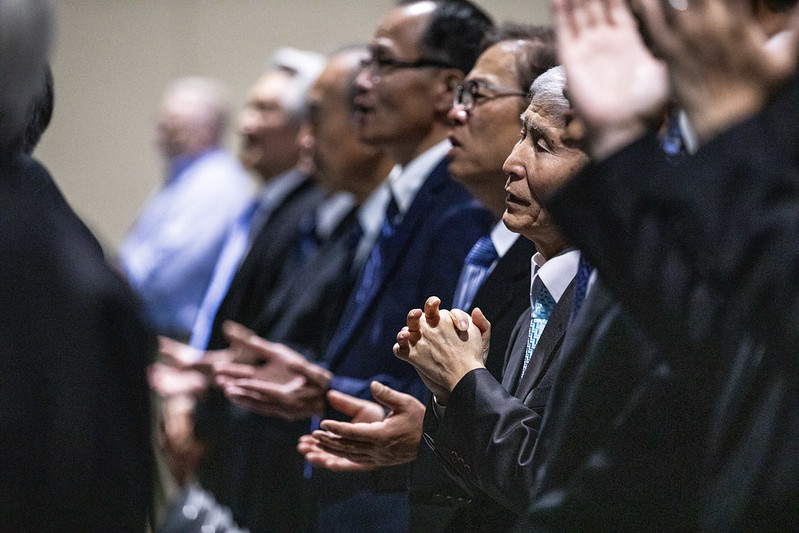 elderly Korean men worshipping Book of Church Order PCA